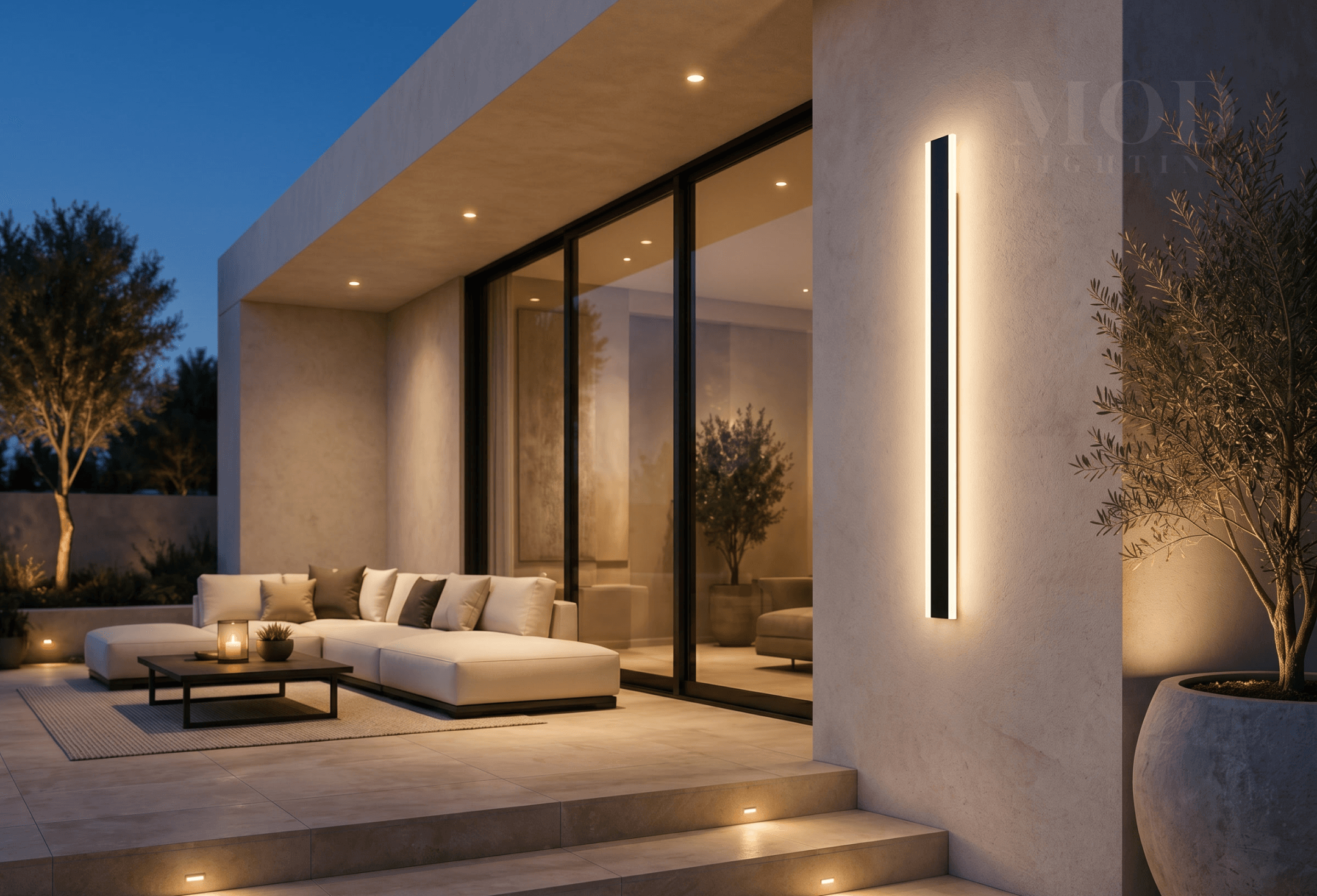 Covered outdoor patio at night with pendant and wall sconce