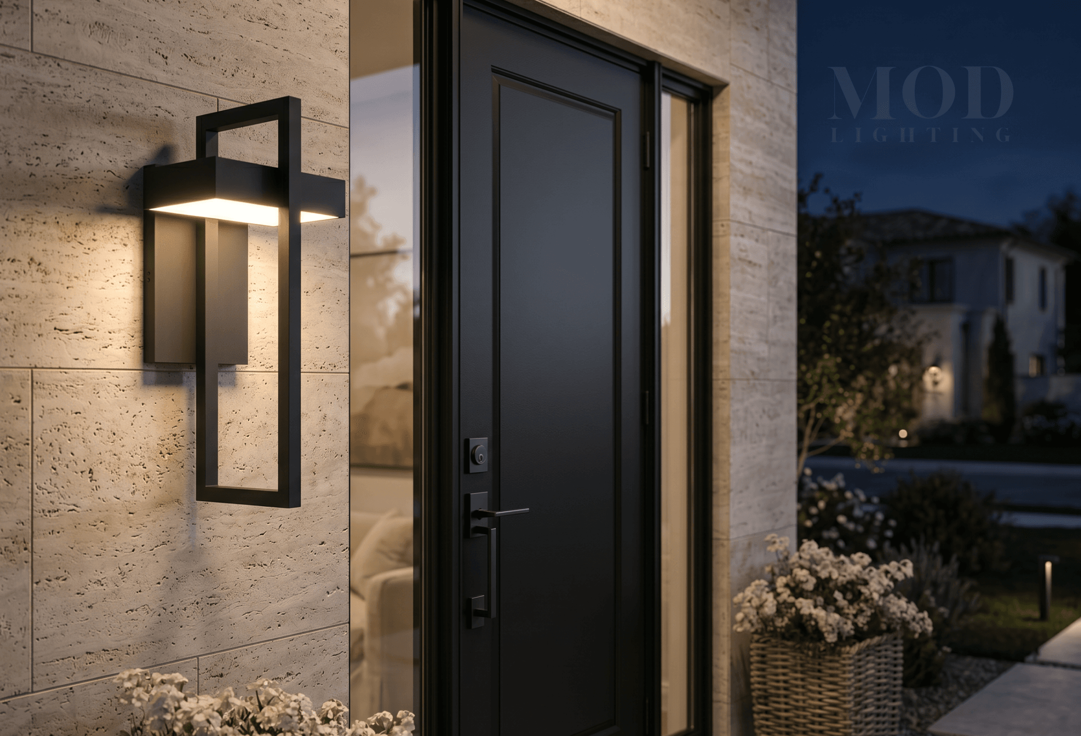 Close-up of a front door at night lit by a warm modern outdoor sconce