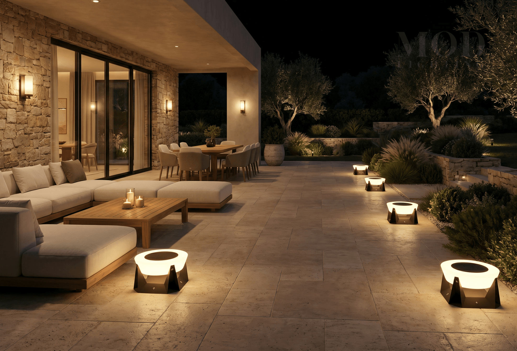 People enjoying a warmly lit modern outdoor patio at night