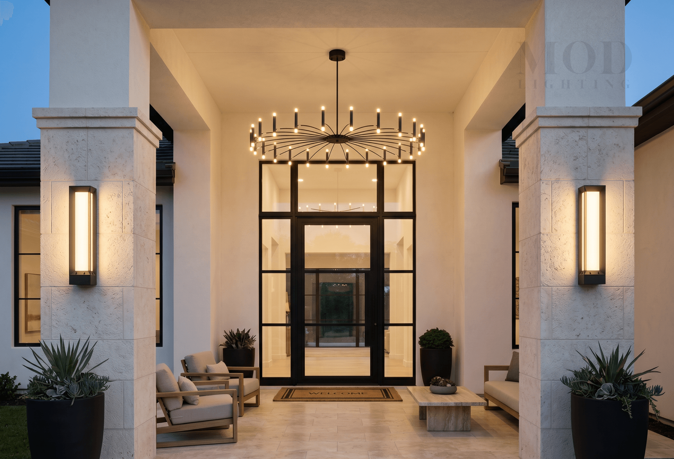 Statement pendant lantern on a large covered front porch at night