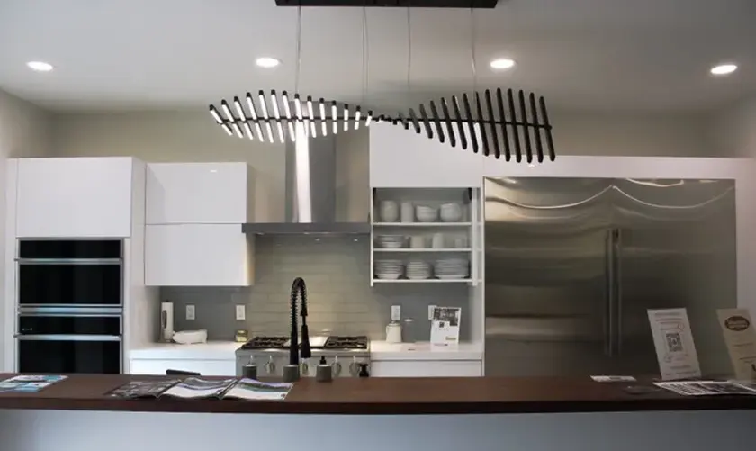 Linear sculptural pendant over a kitchen island